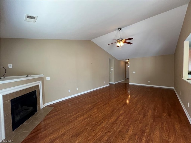 111 Braewyck Ln, King, NC 27021 - unfurnished living room featuring ceiling fan, wood finished floors, a tile fireplace, and vaulted ceiling
