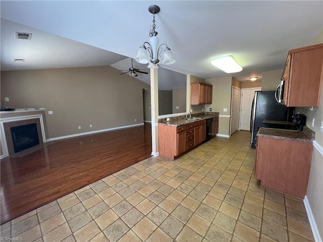 111 Braewyck Ln, King, NC 27021 - kitchen with open floor plan, a ceiling fan, dishwasher, brown cabinetry, and dark countertops