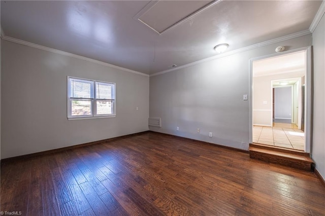 spare room featuring dark wood-type flooring and ornamental molding