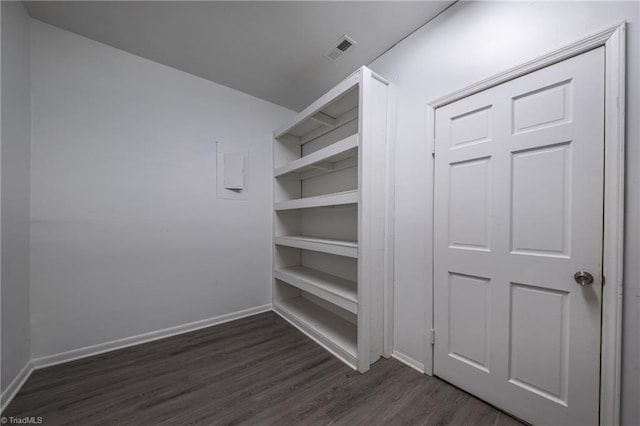 walk in closet with dark hardwood / wood-style flooring