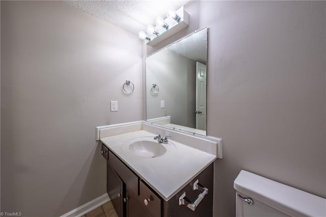 bathroom with tile patterned floors, vanity, and toilet