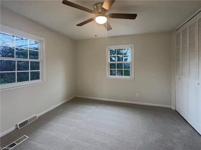 unfurnished bedroom featuring a closet, carpet, visible vents, and baseboards