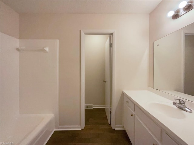 full bathroom featuring baseboards, visible vents, wood finished floors, and vanity