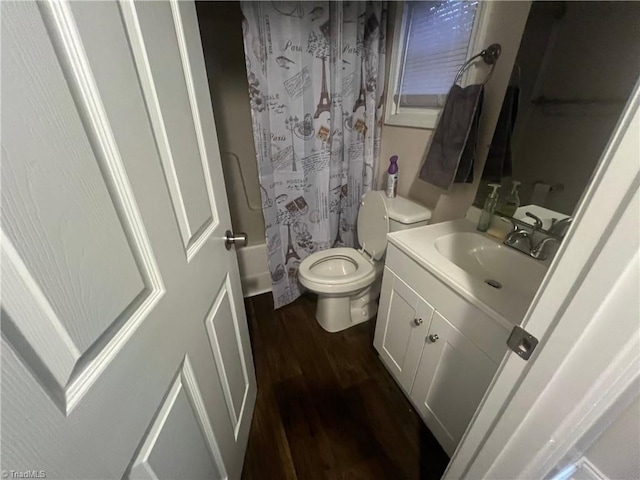 full bathroom featuring vanity, toilet, wood-type flooring, and shower / bath combo with shower curtain