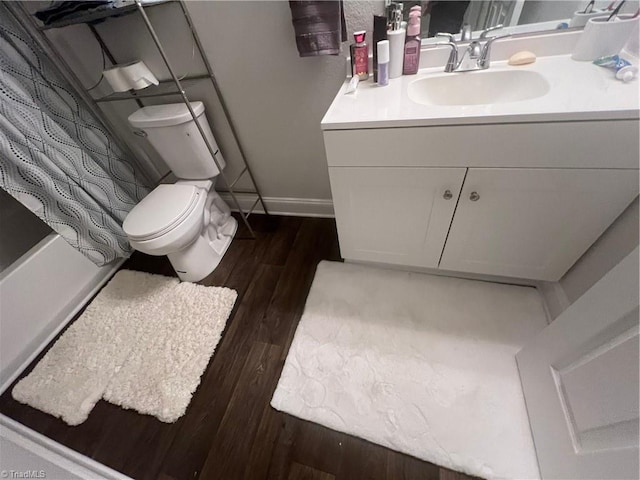 bathroom featuring toilet, vanity, and hardwood / wood-style flooring