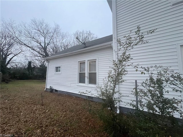 view of side of property with a lawn