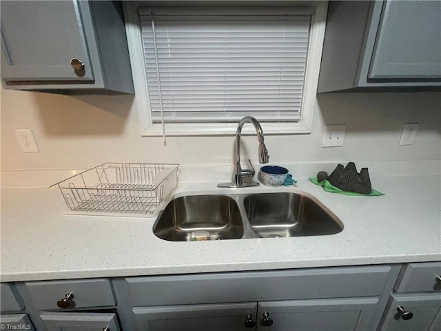 room details with gray cabinetry and sink