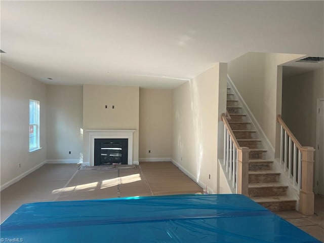 unfurnished living room featuring light tile patterned flooring