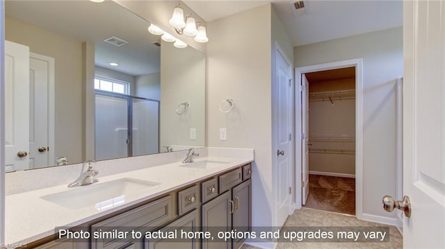 bathroom with tile patterned flooring, an enclosed shower, and vanity