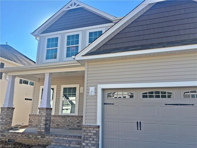 exterior space featuring a garage and covered porch