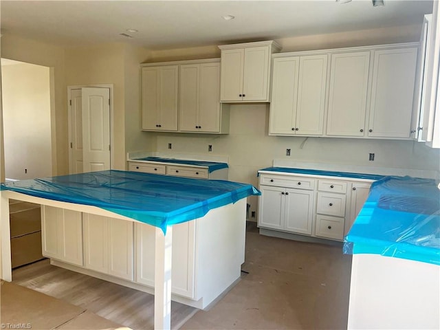 interior space featuring a kitchen island and white cabinets