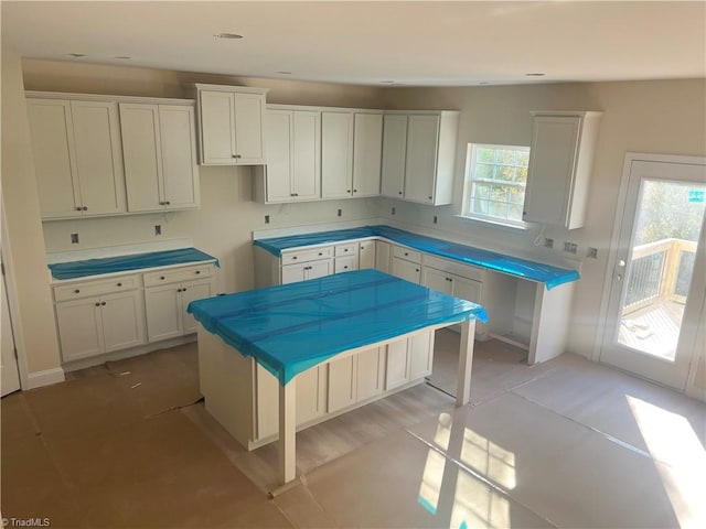 kitchen with white cabinets, a center island, and a breakfast bar