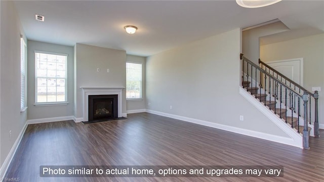 unfurnished living room featuring dark hardwood / wood-style floors