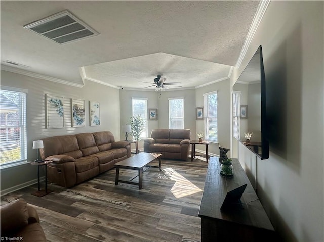 living room featuring a ceiling fan, wood finished floors, visible vents, and baseboards