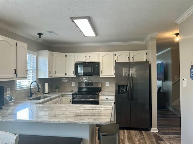 kitchen featuring black microwave, a sink, visible vents, electric stove, and fridge with ice dispenser