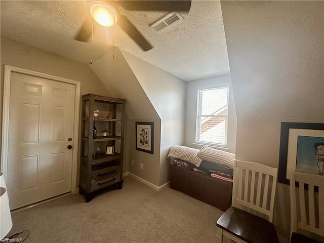 bedroom featuring visible vents, light carpet, vaulted ceiling, a textured ceiling, and baseboards