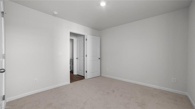 unfurnished room featuring baseboards and carpet floors