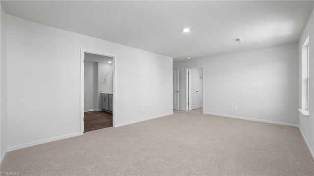 unfurnished room featuring recessed lighting, visible vents, baseboards, and light colored carpet