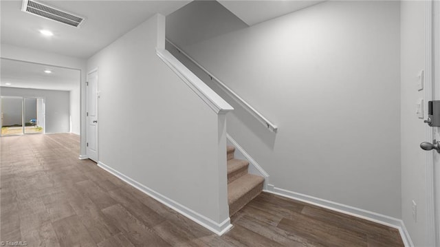 interior space featuring visible vents, stairs, baseboards, and wood finished floors