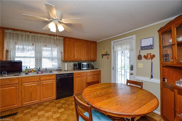 kitchen featuring a sink, light countertops, black dishwasher, stainless steel microwave, and a wealth of natural light