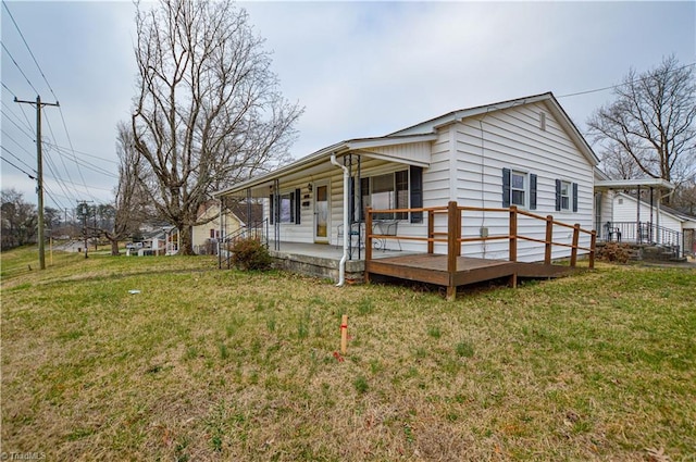 view of side of property featuring a lawn and covered porch