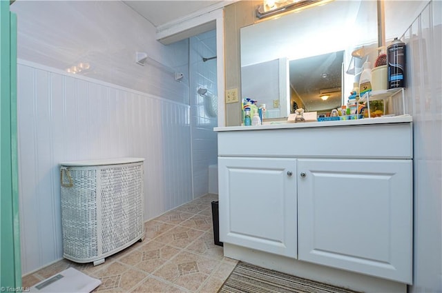 full bath featuring vanity, tile patterned floors, and a shower