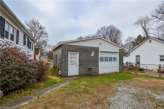 detached garage with driveway and fence