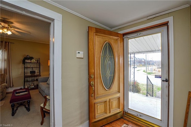 entryway with ceiling fan and crown molding