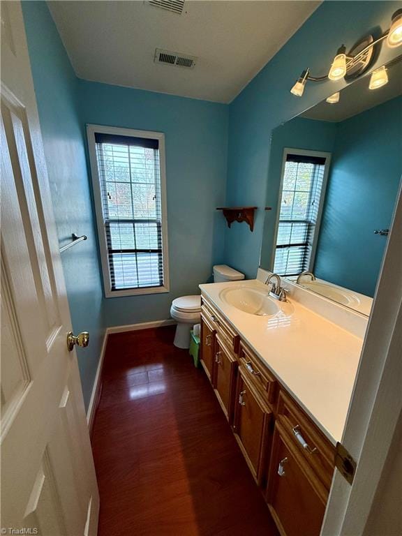 bathroom with vanity, wood-type flooring, and toilet