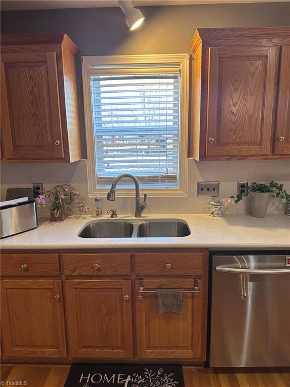 kitchen with dishwasher, hardwood / wood-style floors, and sink