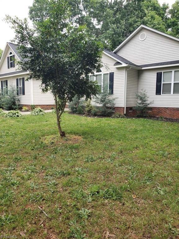 view of home's exterior with a yard