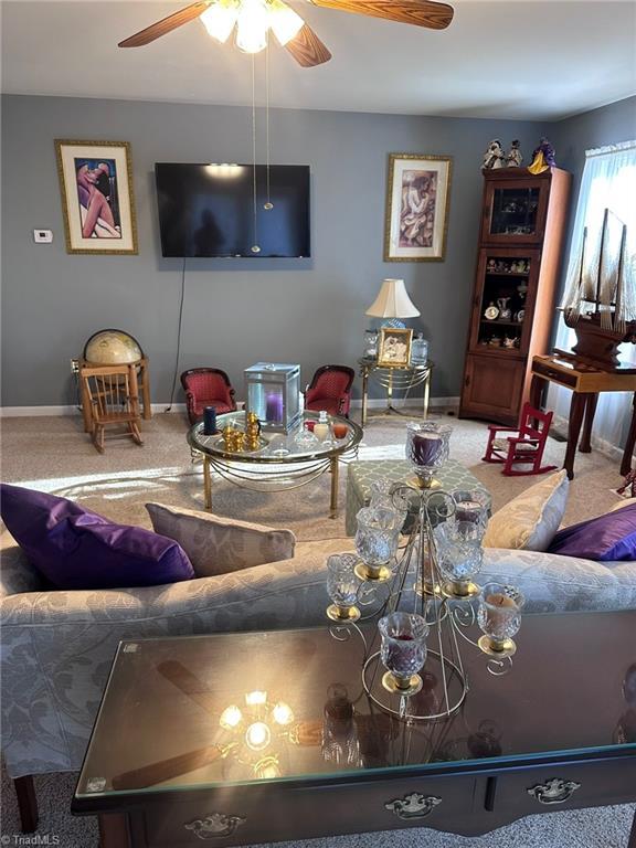 living room with carpet flooring and ceiling fan