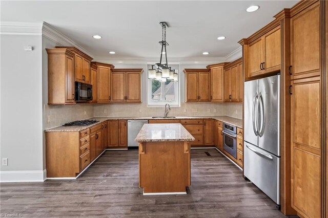 kitchen featuring hanging light fixtures, stainless steel appliances, dark hardwood / wood-style floors, and a kitchen island