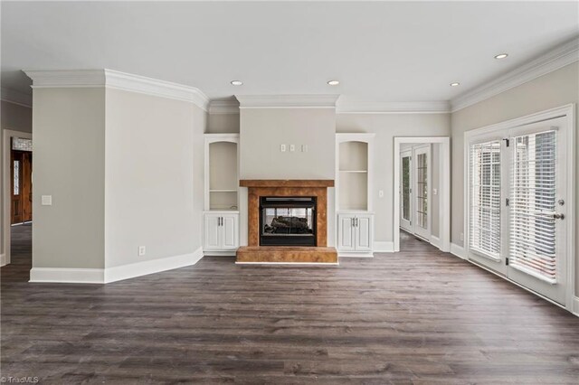 unfurnished living room with dark hardwood / wood-style floors, a multi sided fireplace, ornamental molding, and a healthy amount of sunlight