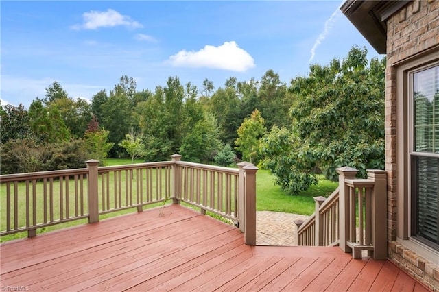 wooden terrace featuring a yard