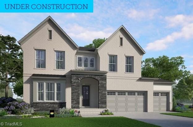 view of front of property with stone siding, an attached garage, driveway, and a front yard