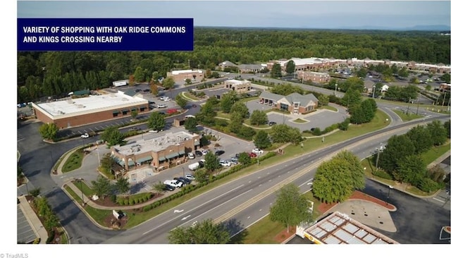 birds eye view of property featuring a view of trees