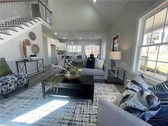 living area featuring recessed lighting, high vaulted ceiling, and wood finished floors