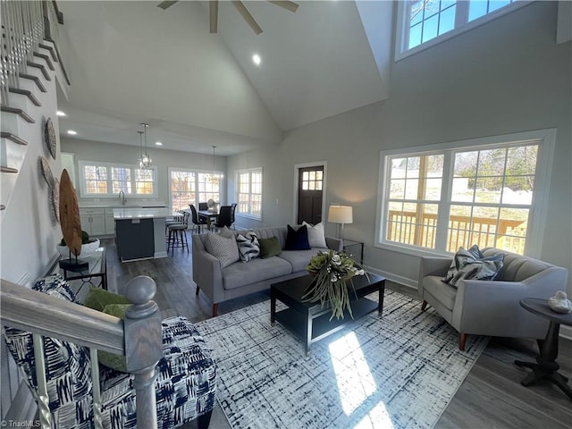 living room featuring recessed lighting, baseboards, high vaulted ceiling, and dark wood-style floors