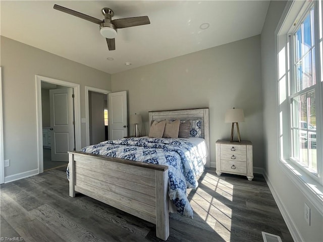 bedroom featuring dark wood finished floors, ceiling fan, and baseboards