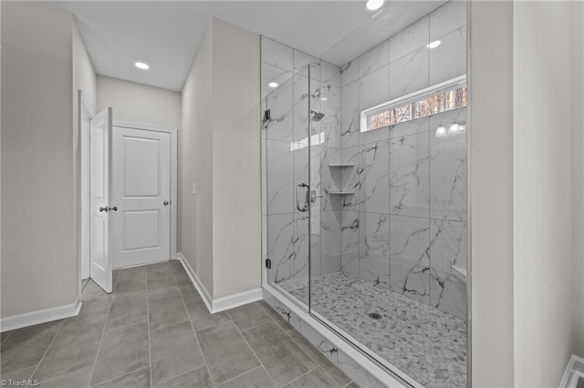 full bath with a marble finish shower, tile patterned flooring, recessed lighting, and baseboards