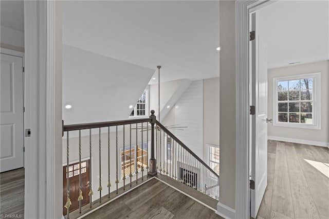 stairway with recessed lighting, baseboards, and wood finished floors