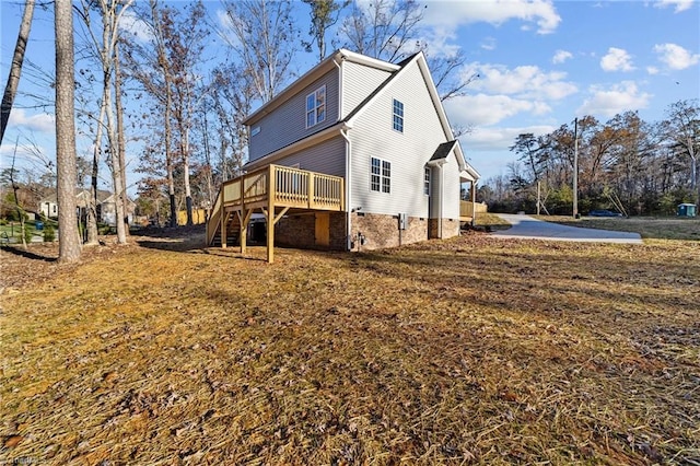 view of home's exterior featuring stairway and a wooden deck