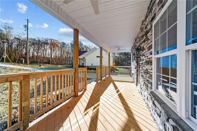 wooden terrace featuring ceiling fan