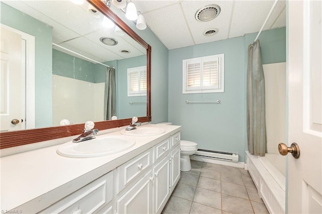 bathroom with a baseboard heating unit, toilet, tile patterned flooring, double vanity, and shower / bath combination with curtain