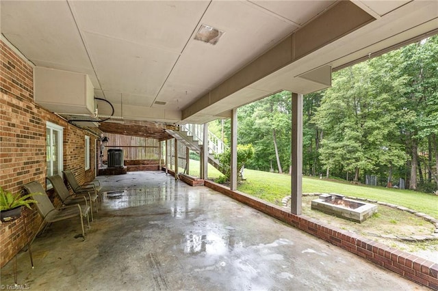 view of patio / terrace featuring stairs and an outdoor fire pit