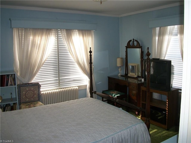 bedroom with radiator heating unit and crown molding