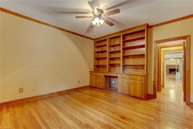 6400 Muirfield Dr, Greensboro, NC 27410 - unfurnished office featuring built in desk, ceiling fan, light wood-style flooring, a fireplace, and ornamental molding