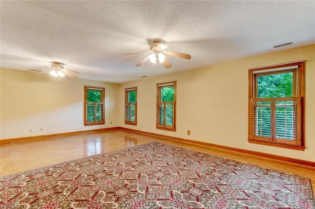 6400 Muirfield Dr, Greensboro, NC 27410 - spare room featuring a ceiling fan, wood finished floors, and a textured ceiling