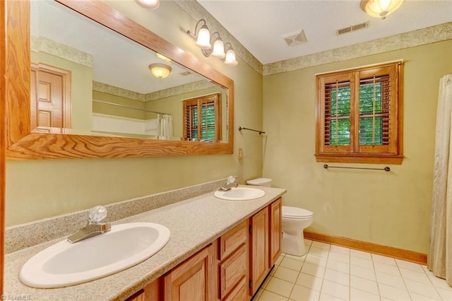 6400 Muirfield Dr, Greensboro, NC 27410 - full bath with double vanity, tile patterned flooring, and curtained shower